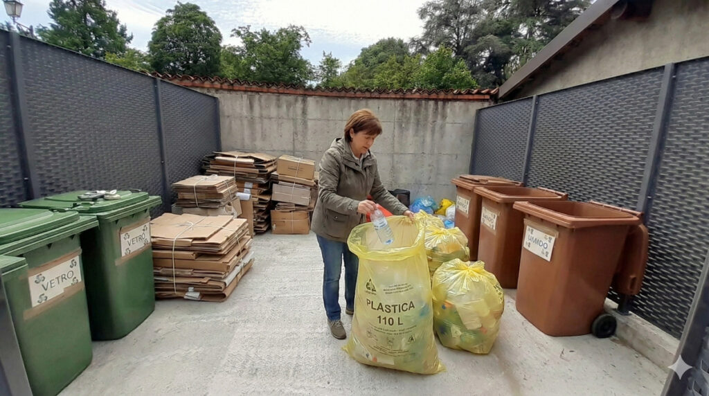 Raccolta differenziata in condominio: regole, multe e prevenzione persona che differenzia in area rifiuti ordinata